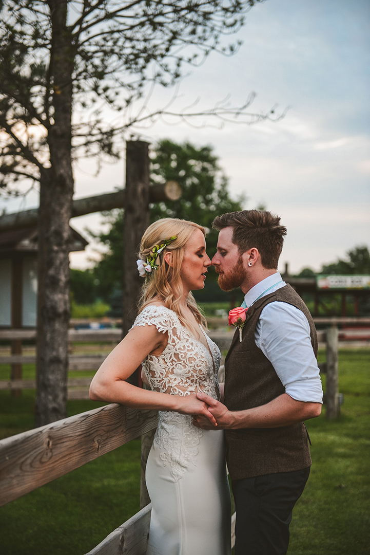 a groom going into kiss his bride at the All Season Orchard in Woodstock