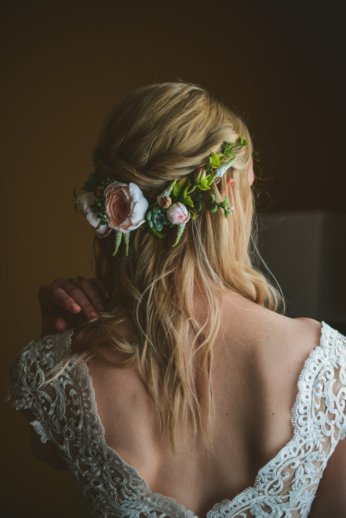 a naturally lit image of the brides flower crown as the bride looks out the window in Woodstock IL