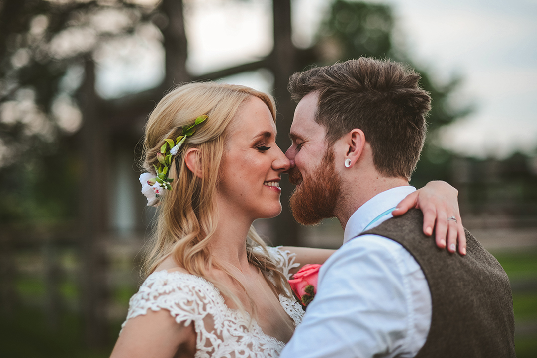 a bride going into kiss her groom at the All Season Apple Orchard