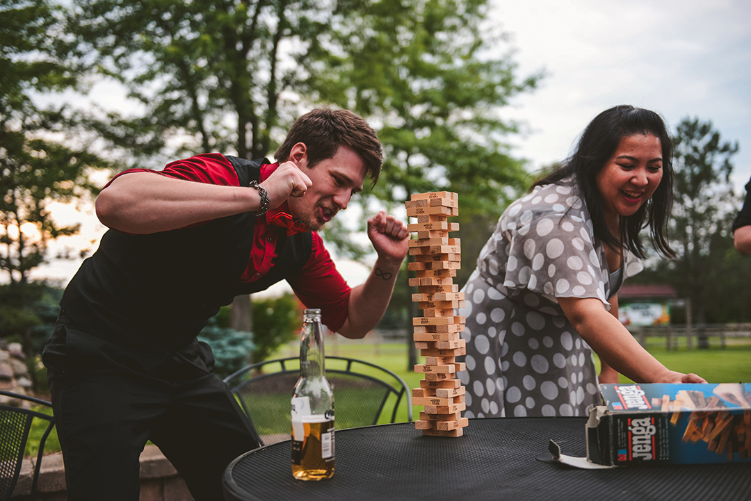 a man and a woman playing Jenga outside at the All Season Orchard in Woodstock IL