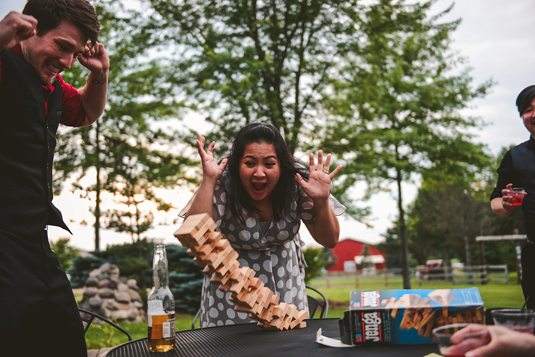 a Jenga tower falling over as two wedding guests scream at the All Season Orchard in Woodstock