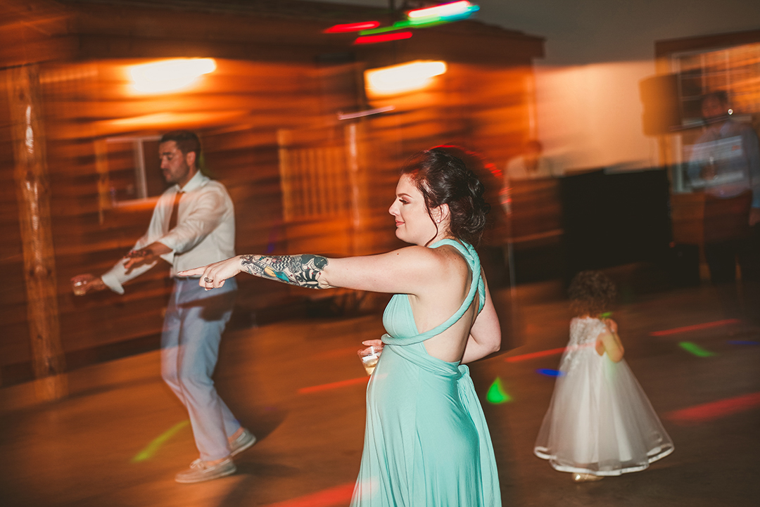 one of the tattooed bridesmaids dancing in a blue dress at the All Season Orchard