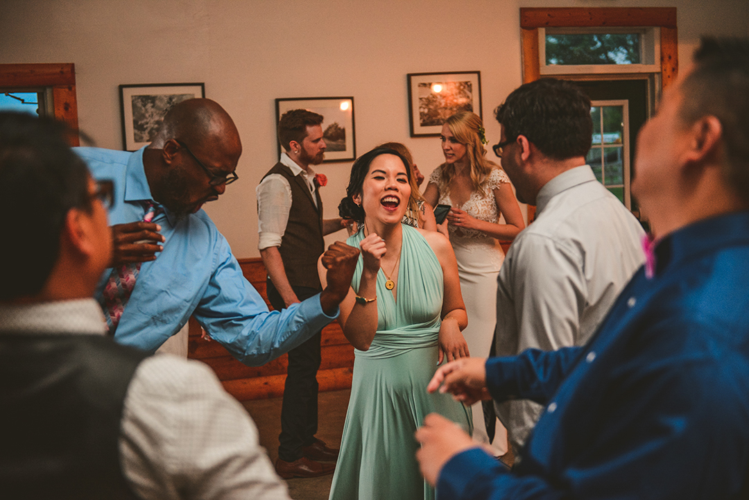 a bridesmaid in a light blue dress dancing with a bunch of her friends in Woodstock IL