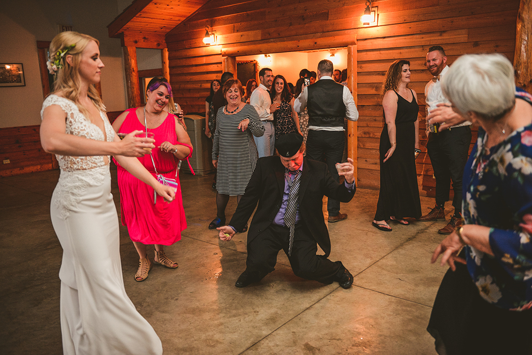 a wedding guest dancing with a bunch of women at a wedding reception in Woodstock IL