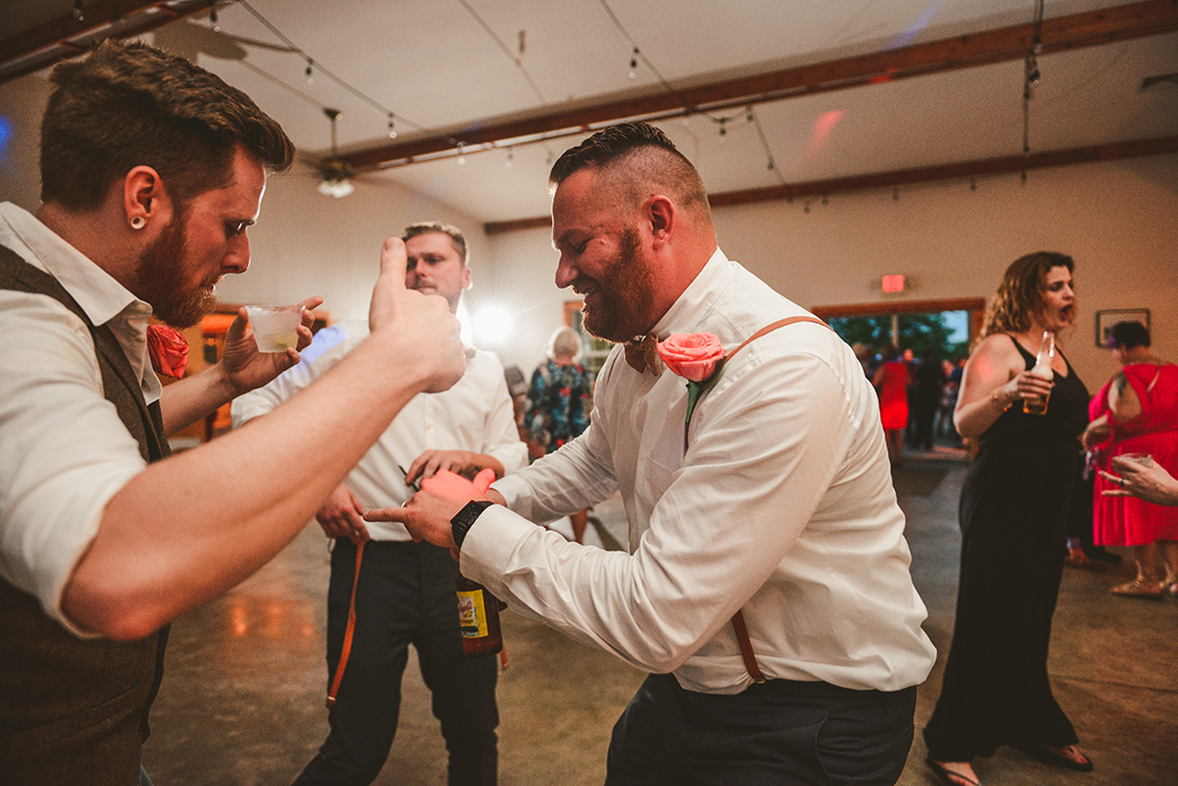 all of the groomsmen dancing on the dance floor of All Season Orchard