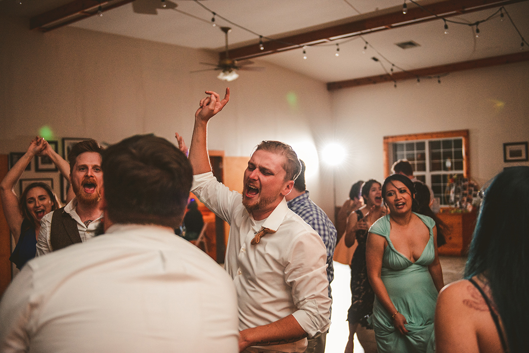 groomsman dancing with bridal party at wedding reception at the All Season Orchard in Woodstock