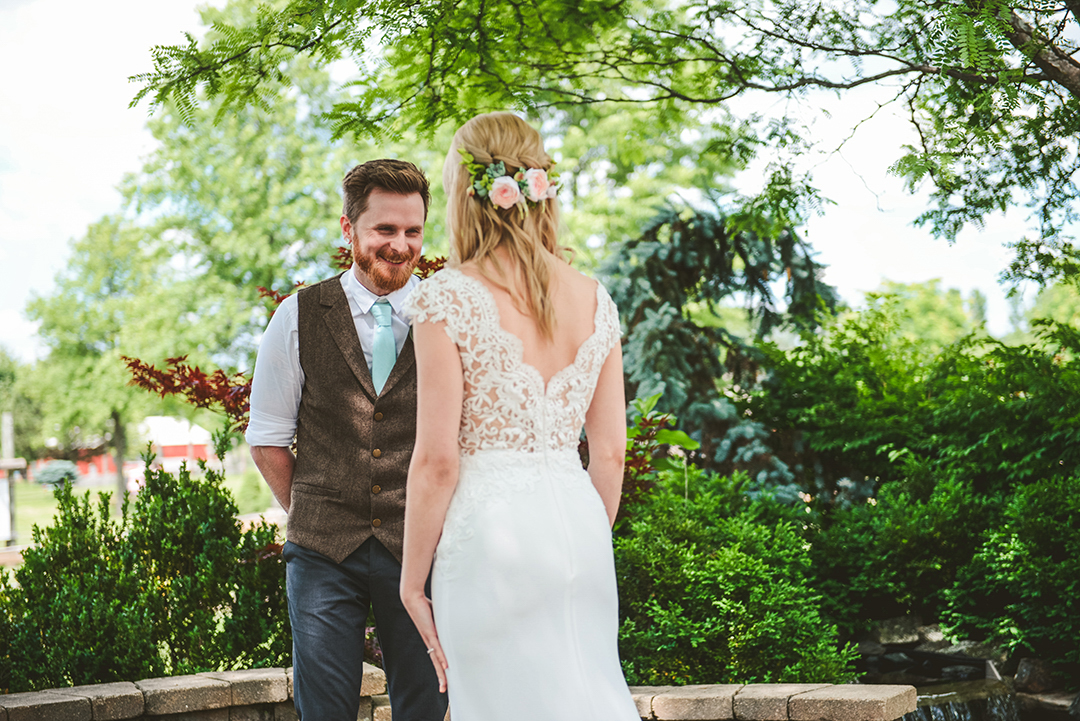 a groom smiling big as he sees his bride for the first time at the All Seasons Orchard in Woodstock IL