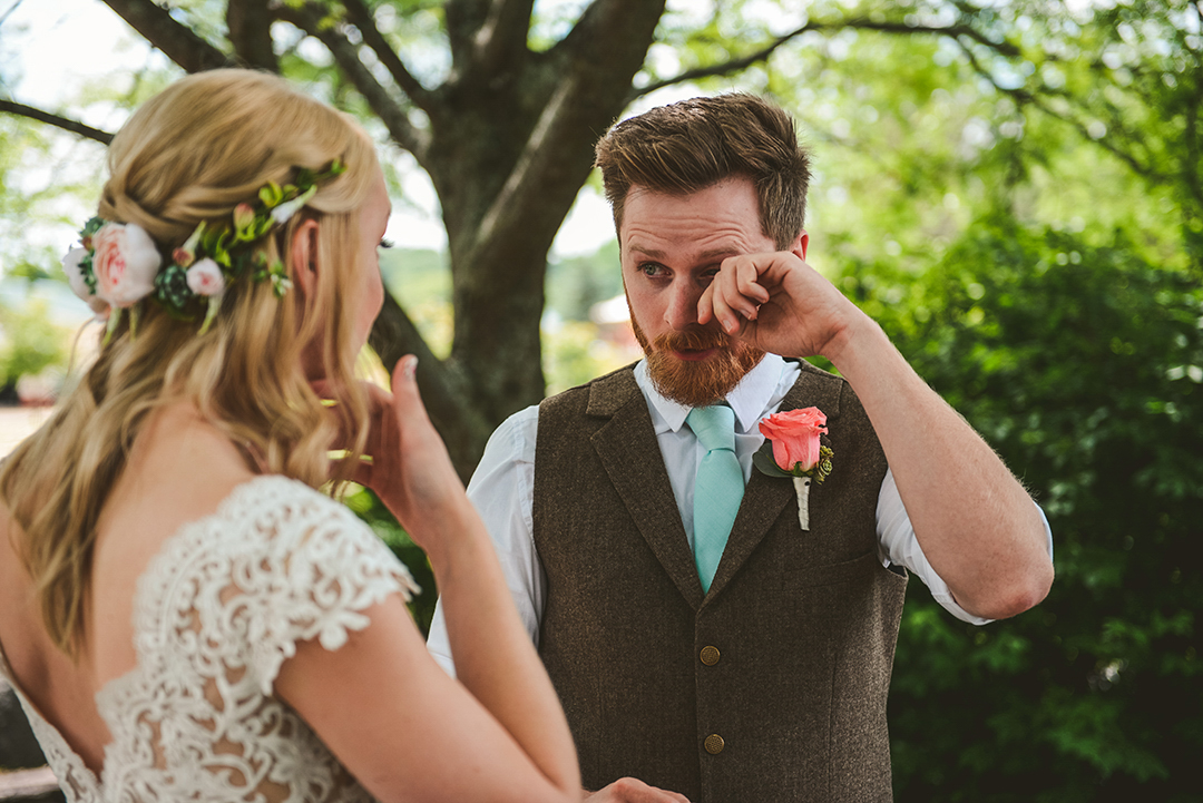 a groom wiping away a tear as he sees his bride for the first time at the All Seasons Orchard in Woodstock