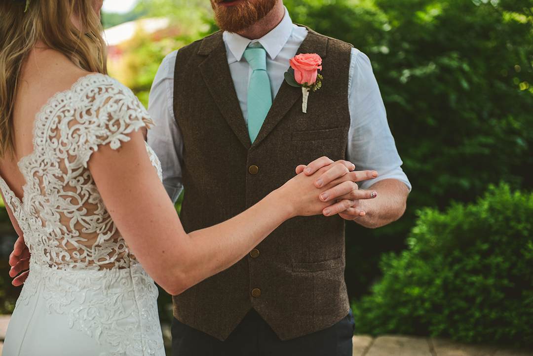 a bride and groom holding hands during the first look at the All Seasons Orchard in Woodstock IL