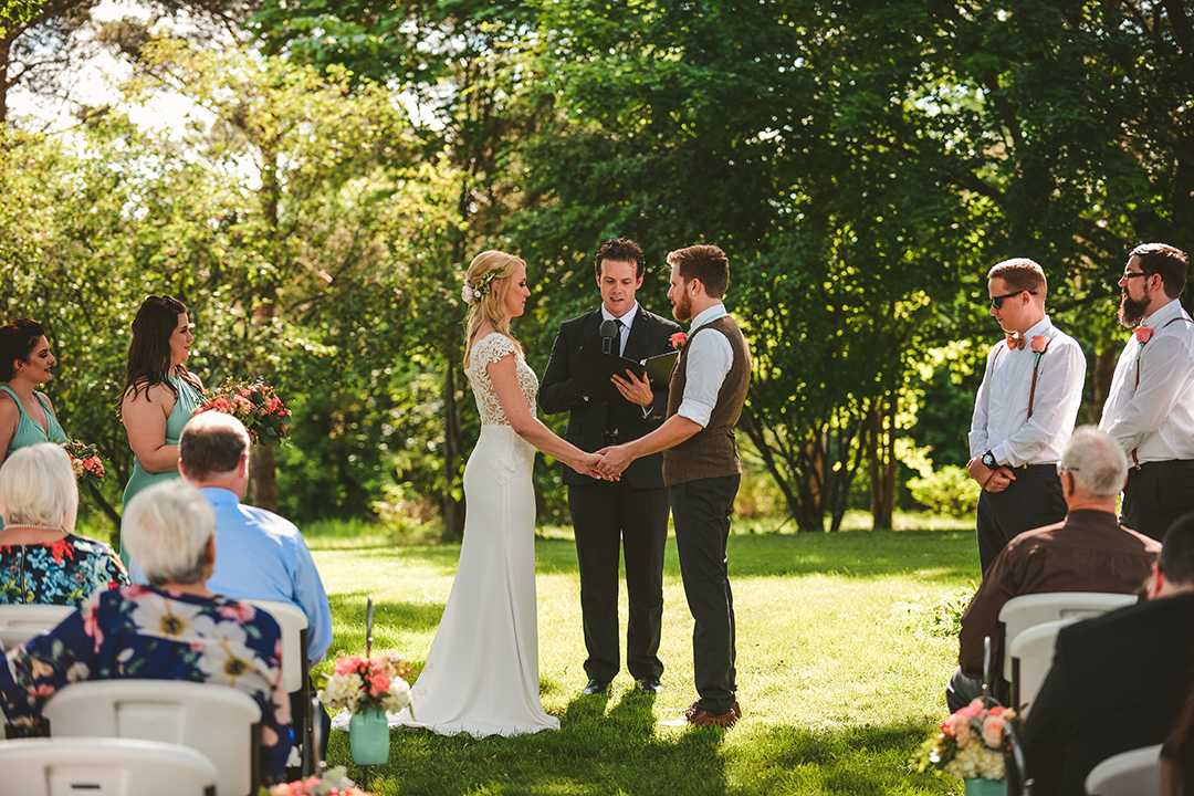 a wedding taking place as all of the bride and grooms friends and family watch