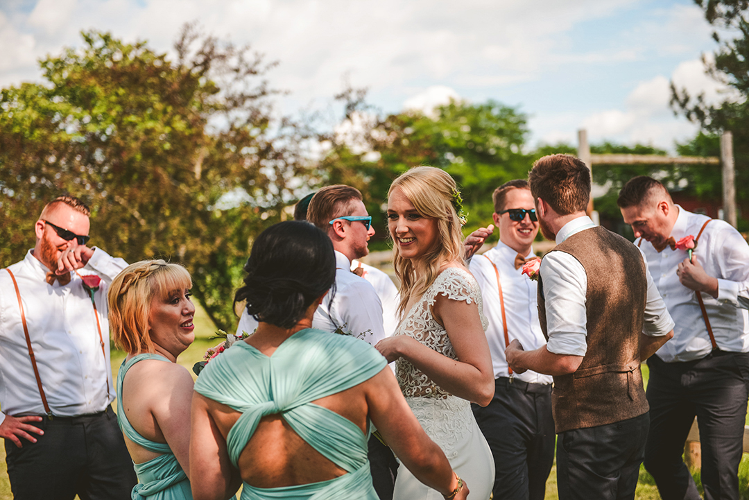 The bride smiling at her bridesmaids after just getting married at the All Season Orchard in Woodstock