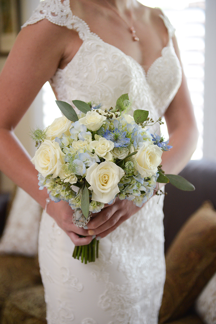 the bride holding her bouquet in front of her beautiful white dress