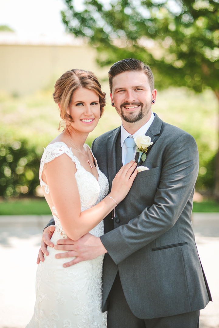 a bride and groom getting close on their wedding day in the warm morning sun