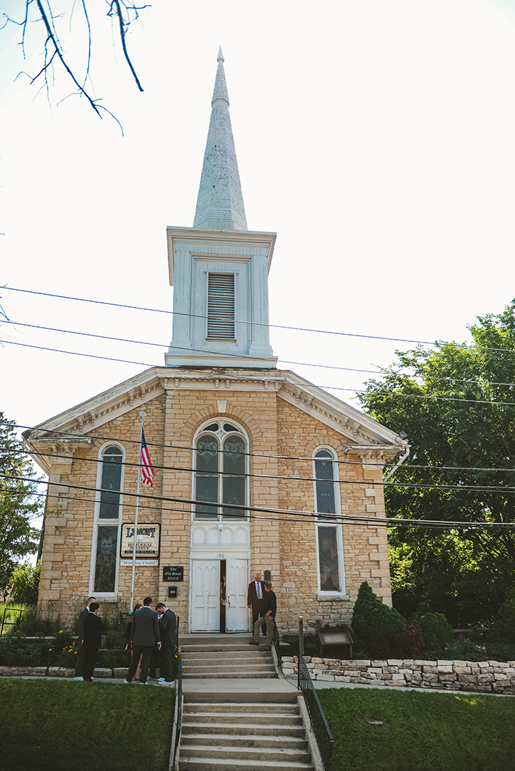 The Old Stone Church in Lemont with wedding guests standing out in front