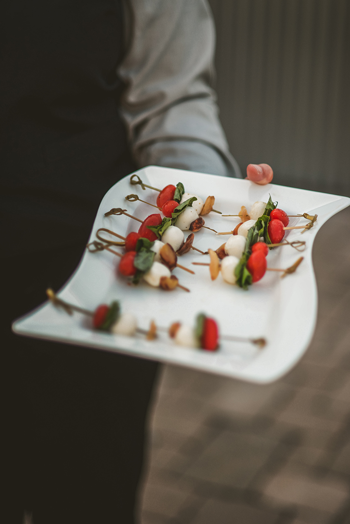 a server holding a plate of skewers at Warehouse 109