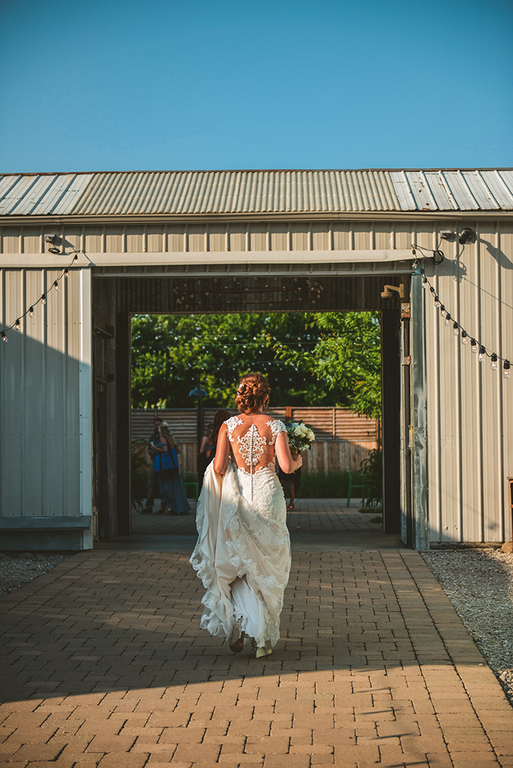 a bride walking into Warehouse 109 in the evening of her wedding day