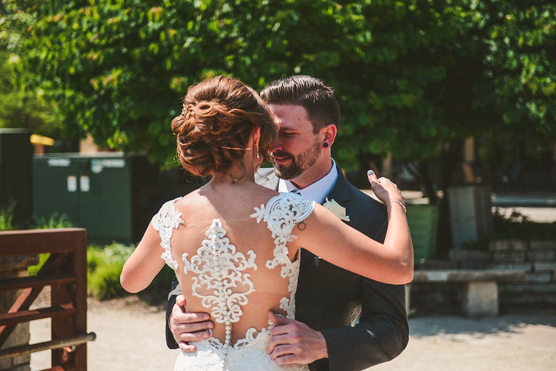 a bride and a groom getting close during their first look on a bridge in Lemont