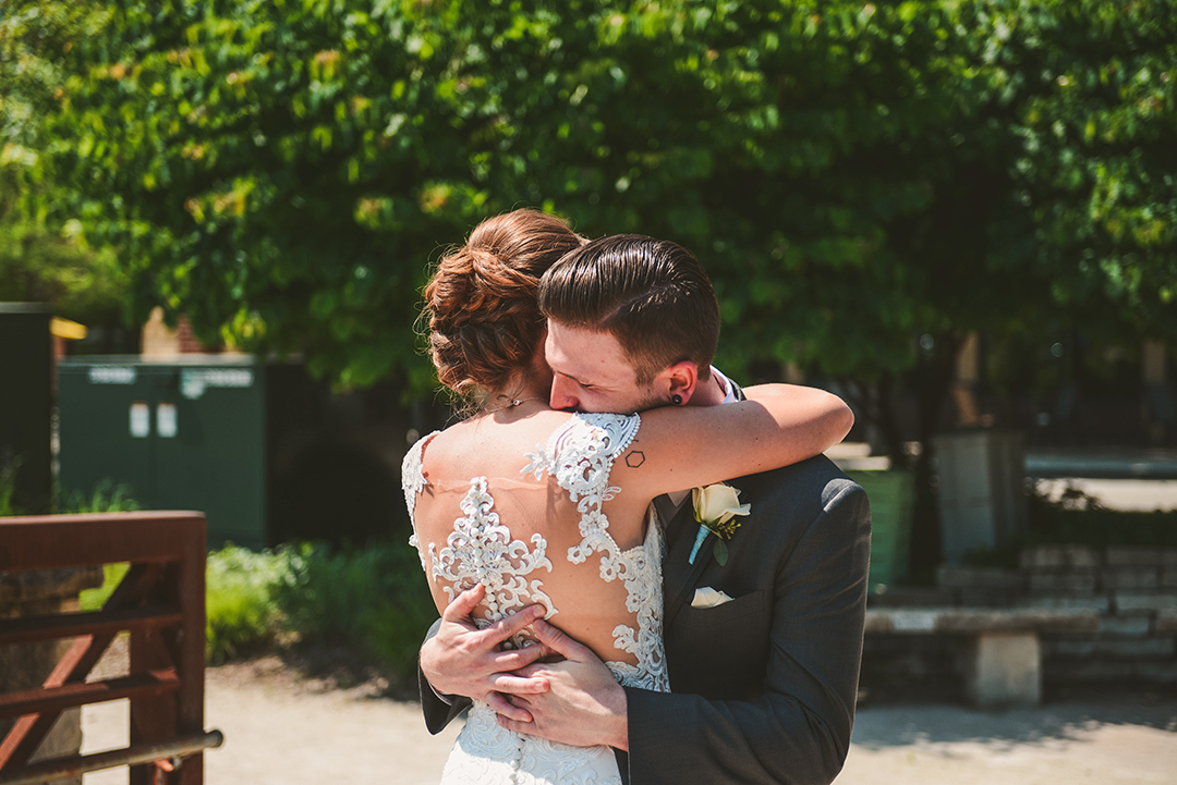 a groom hugging his bride during their first look in Lemont