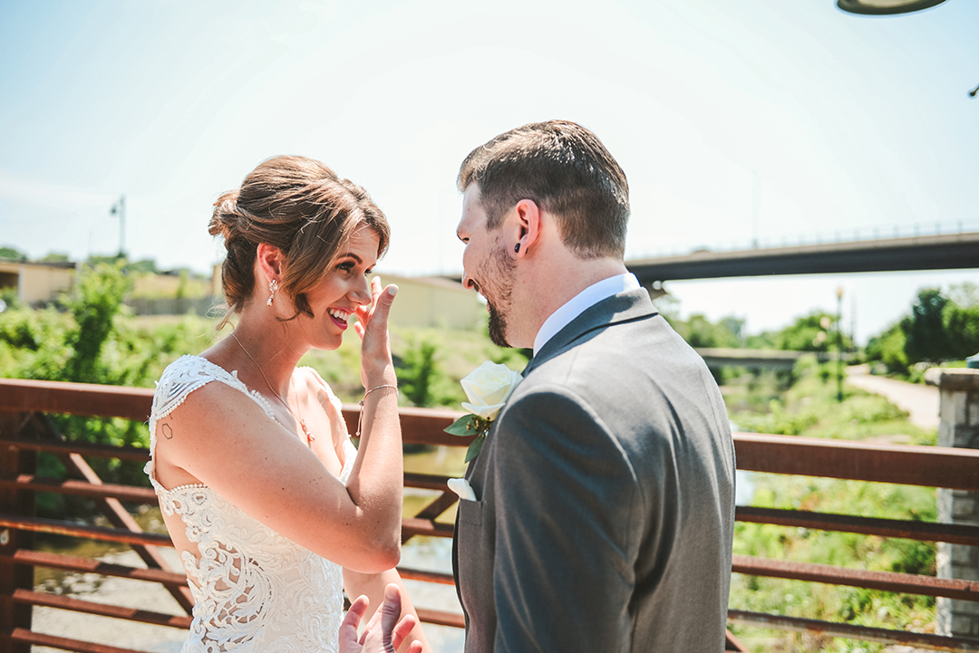 a bride brushing a tear away during her and her husbands first look