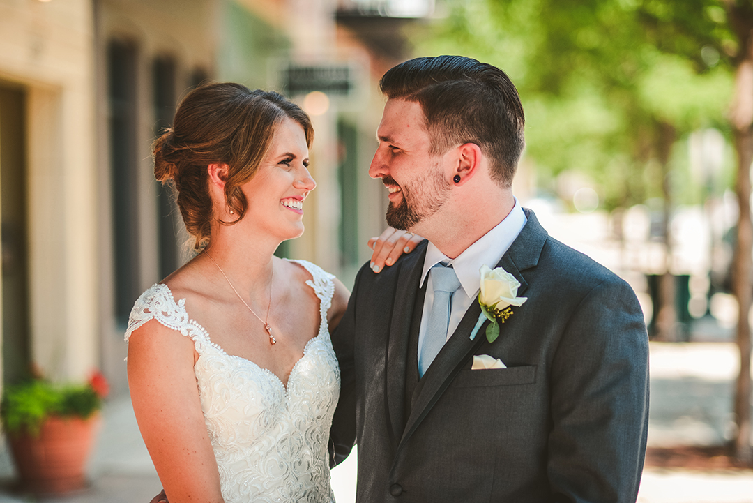 a bride and groom laughing as they hangout before their wedding ceremony