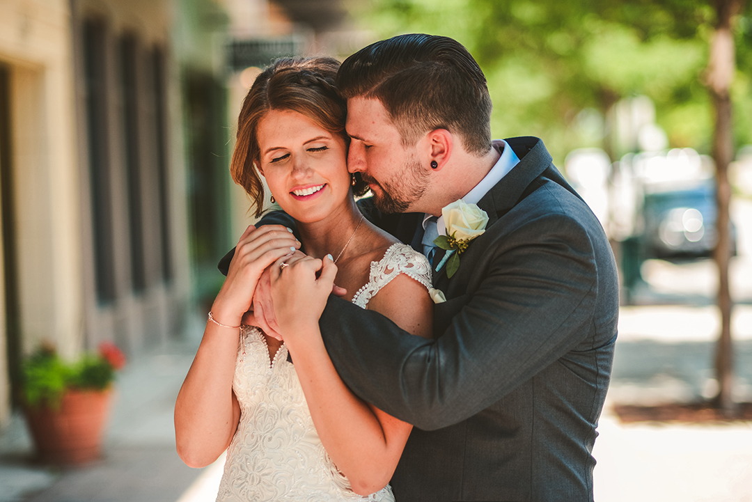 a husband hugging his wife with warm golden light in Lemont