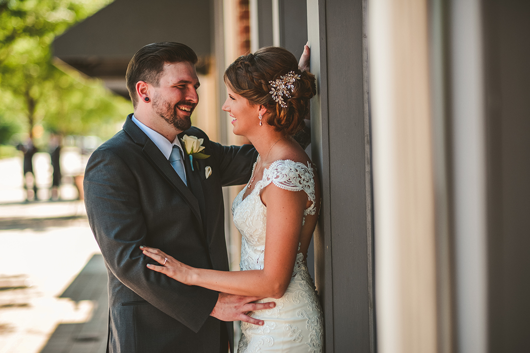 a candid moment of a groom standing with his bride in Lemont