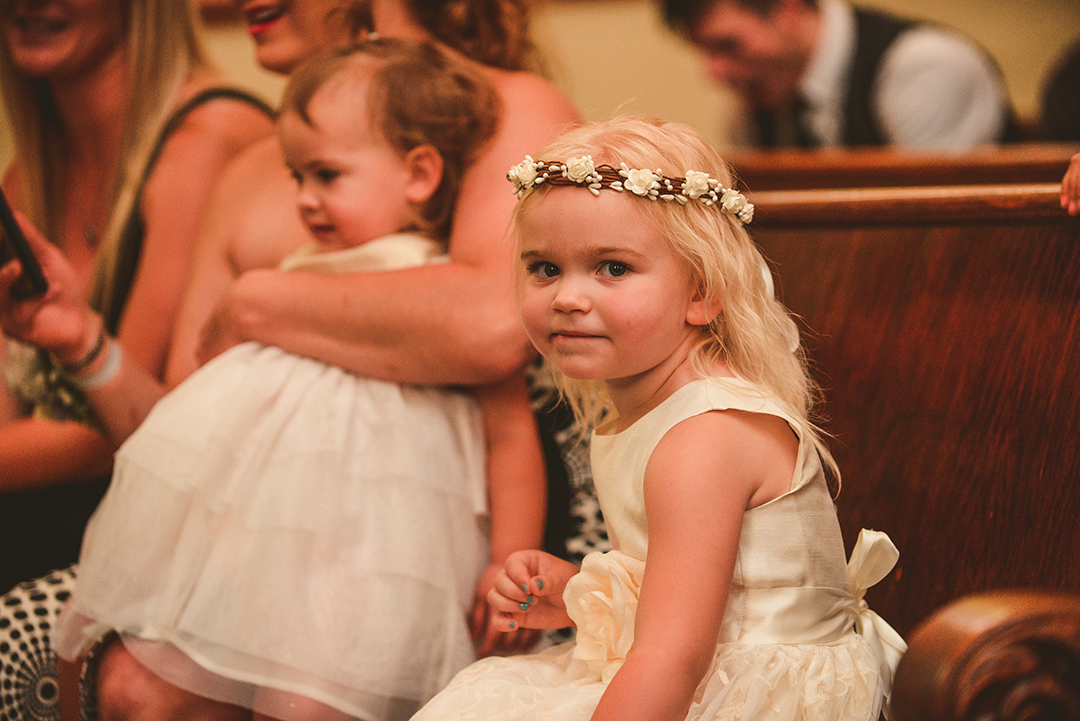 The flower girl looking at the camera at a wedding ceremony in Lockport