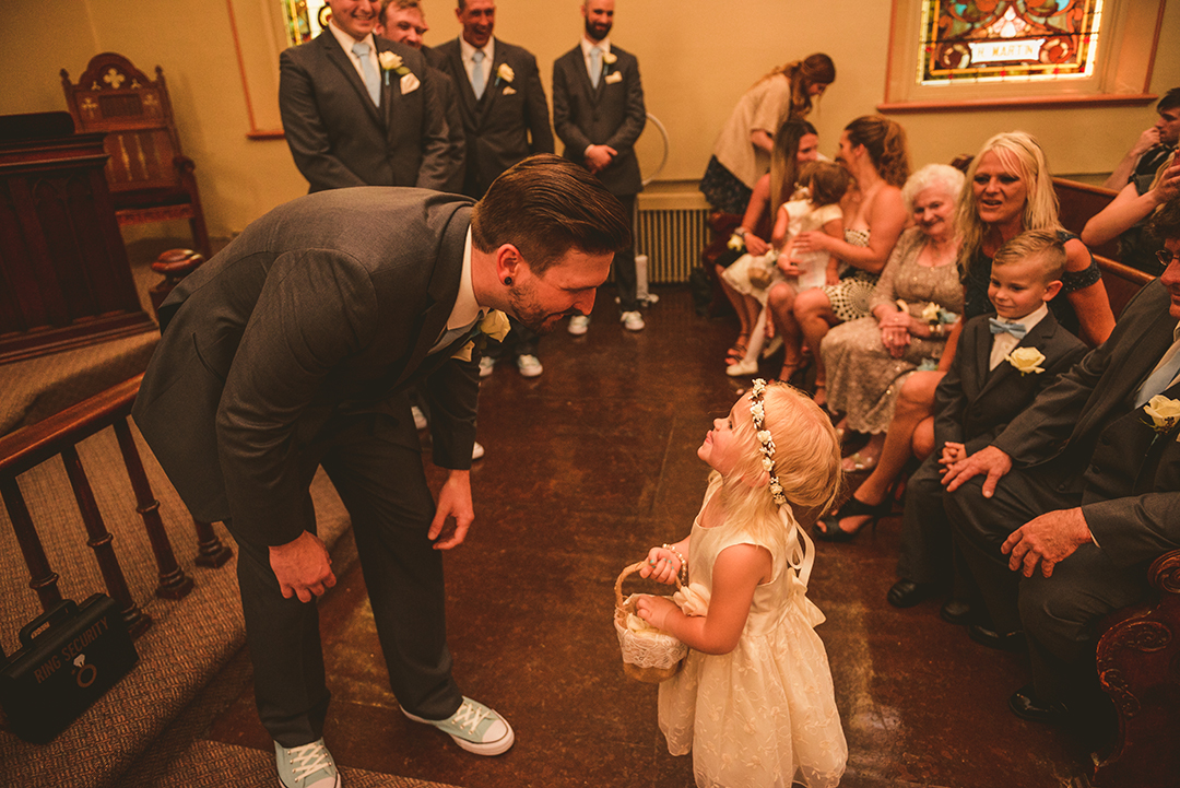 the flower girl sticking out her tongue at a wedding in Lockport