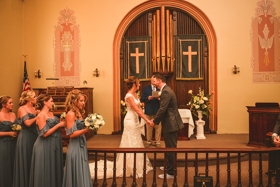 moments after the first kiss, a bride and groom smiling at the alter