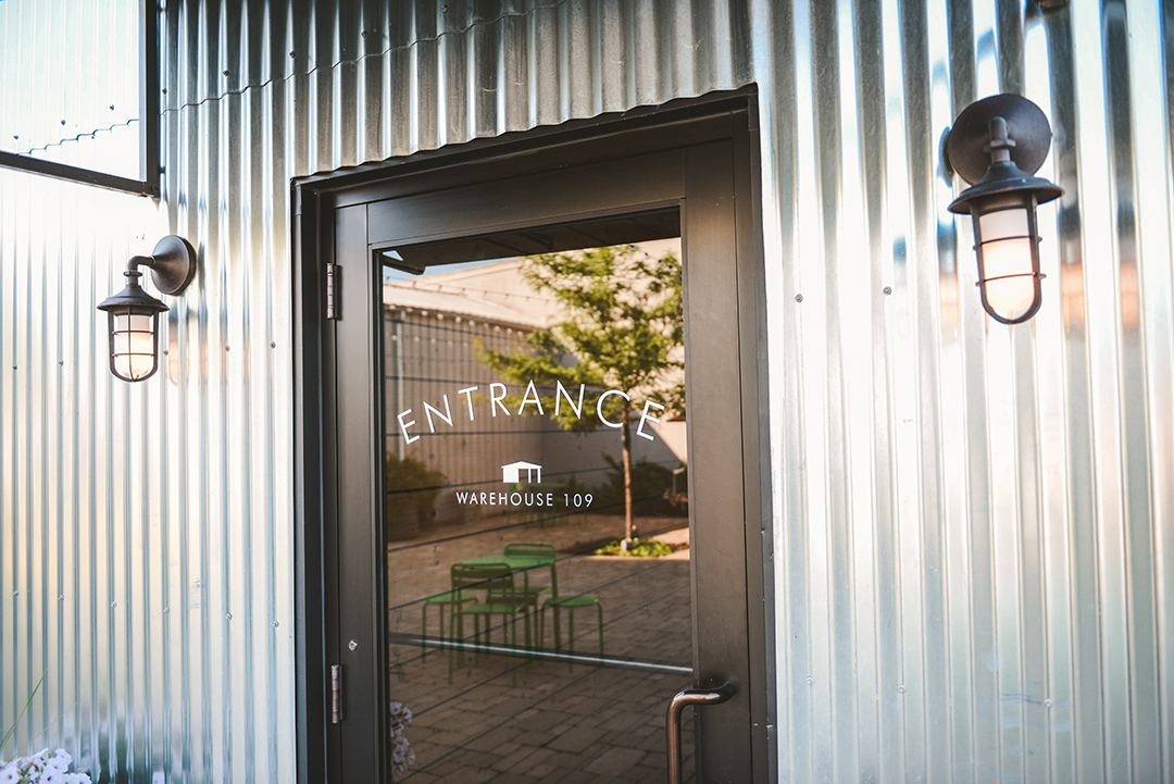 the entrance of warehouse 109 with silver metal siding