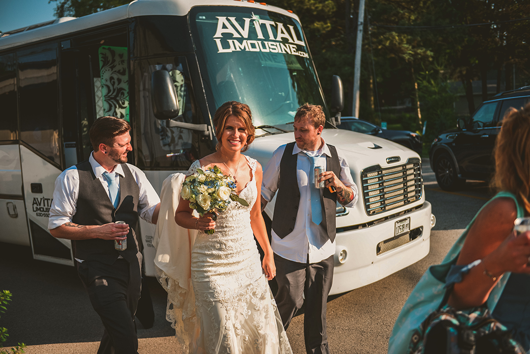 a bride and groom getting off of the avital limousine party bus at Warehouse 109