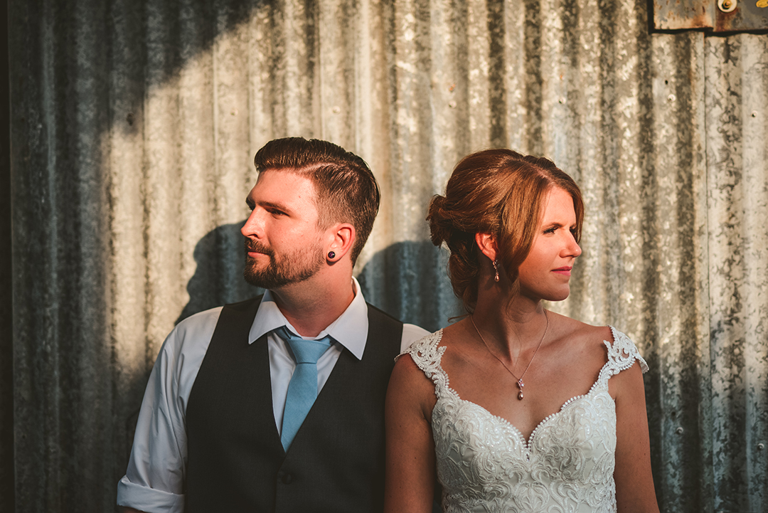 a bride and groom standing in warm evening sun at Warehouse 109 in Plainfield