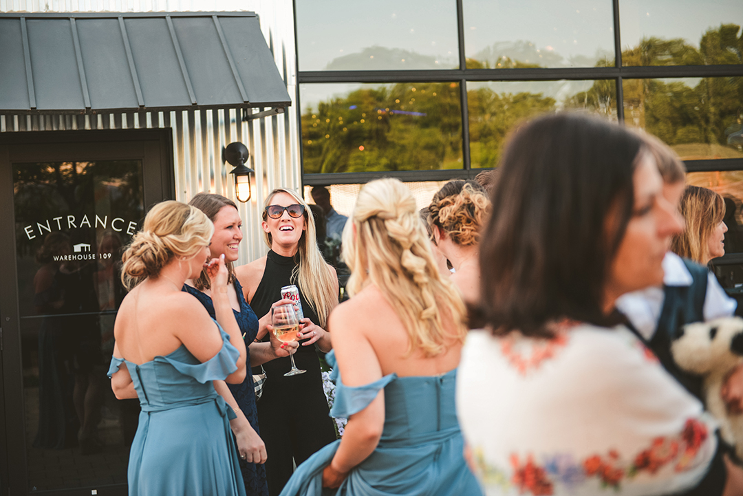 a woman laughing as she talks to the bridesmaids at a Plainfield wedding