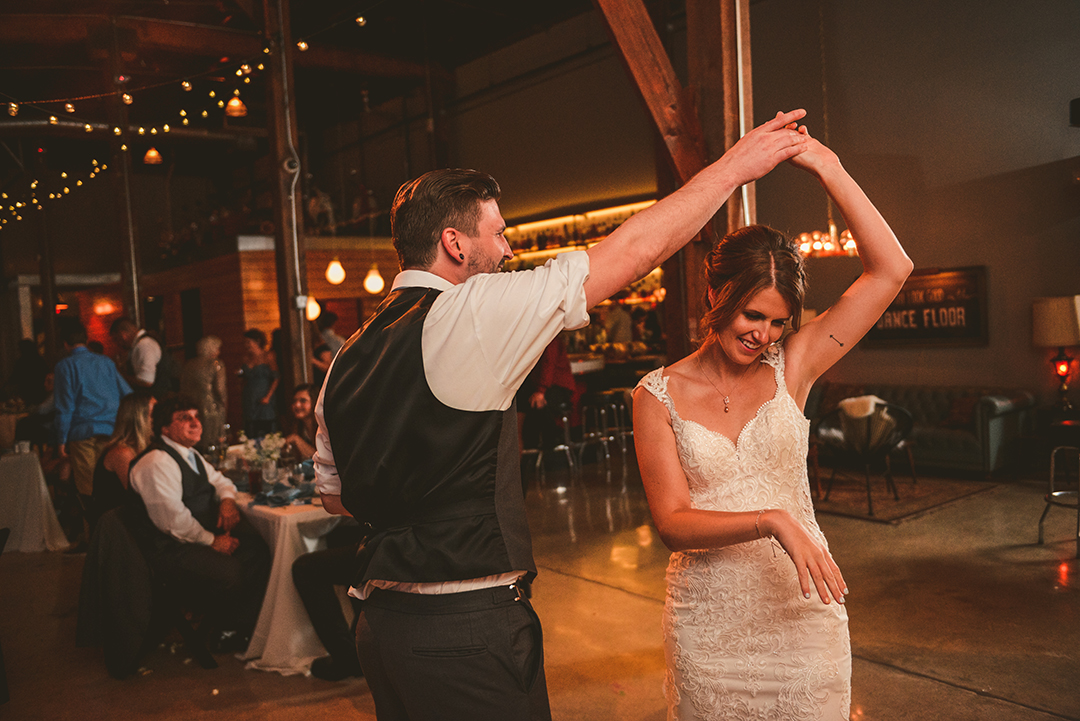 a groom spinning his bride during their first dance at Warehouse 109 in Plainfield