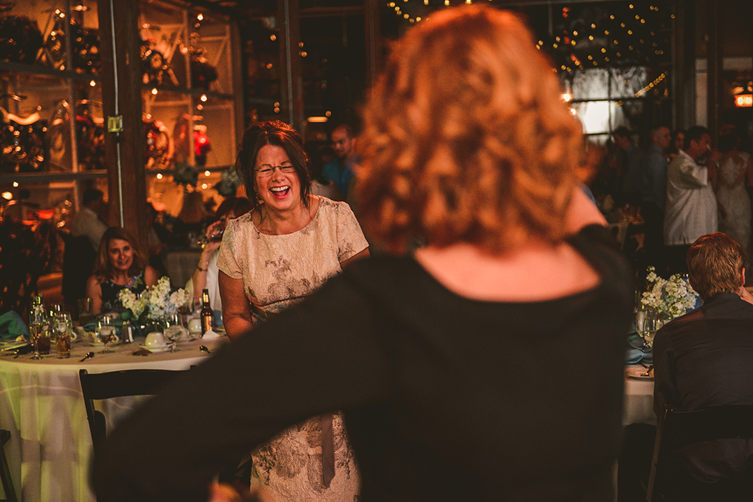 mother of the bride laughing as she dances at a wedding reception at Warehouse 109