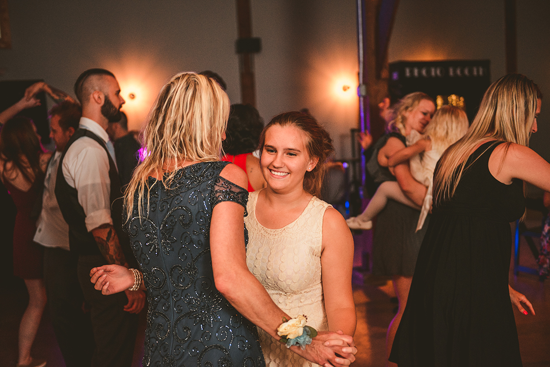 young girl dancing with her mom at a wedding reception