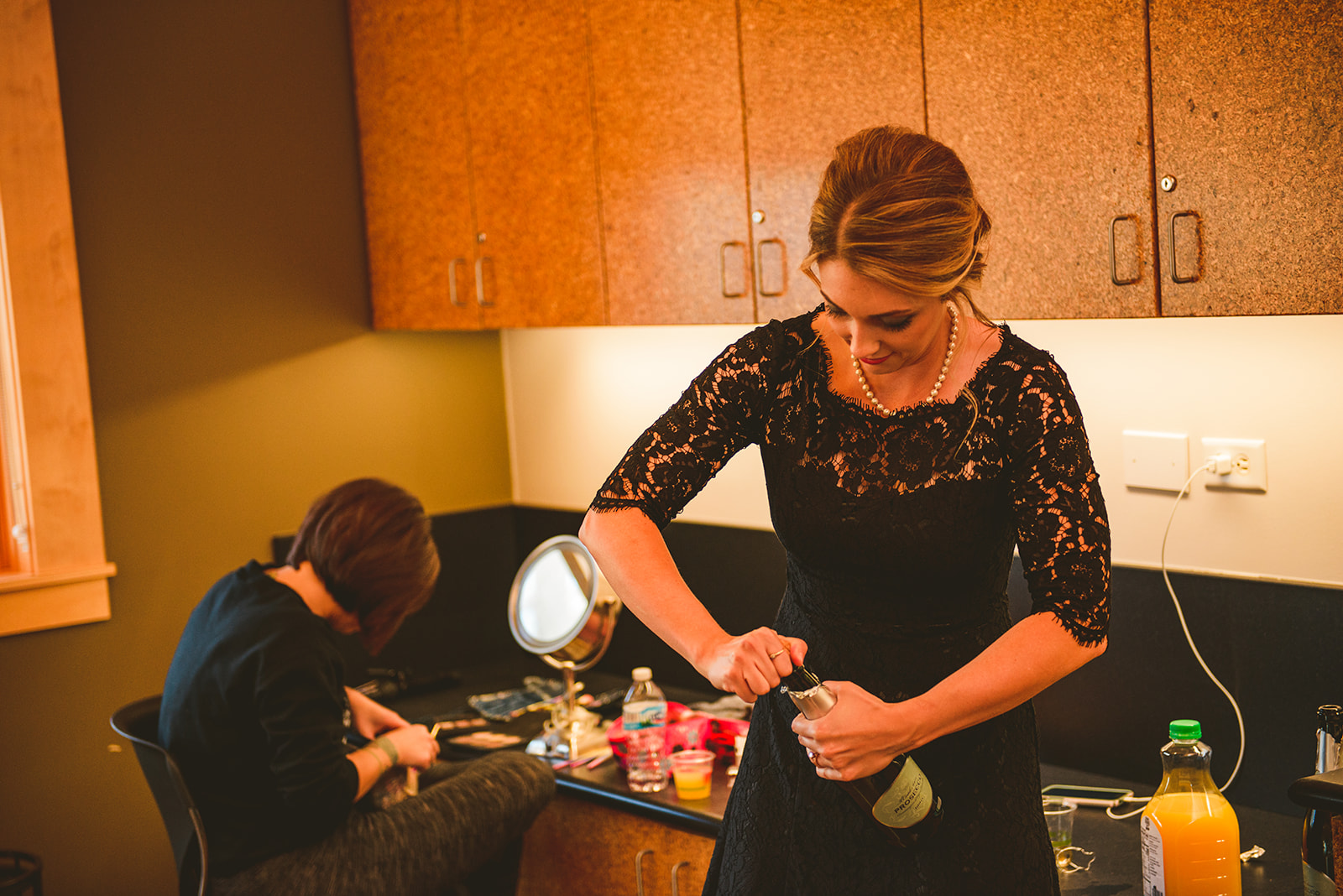 the made of honor opening a bottle of champagne at the Four Rivers Environmental Education Center