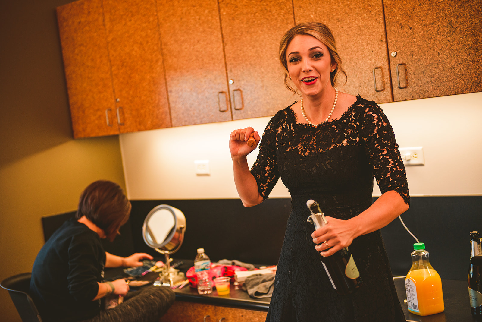 the maid of honor laughing as she spills her drink