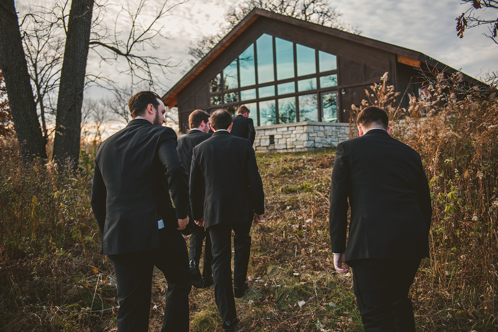 the groom and his groomsmen walking back to the Four Rivers Environmental Education Center