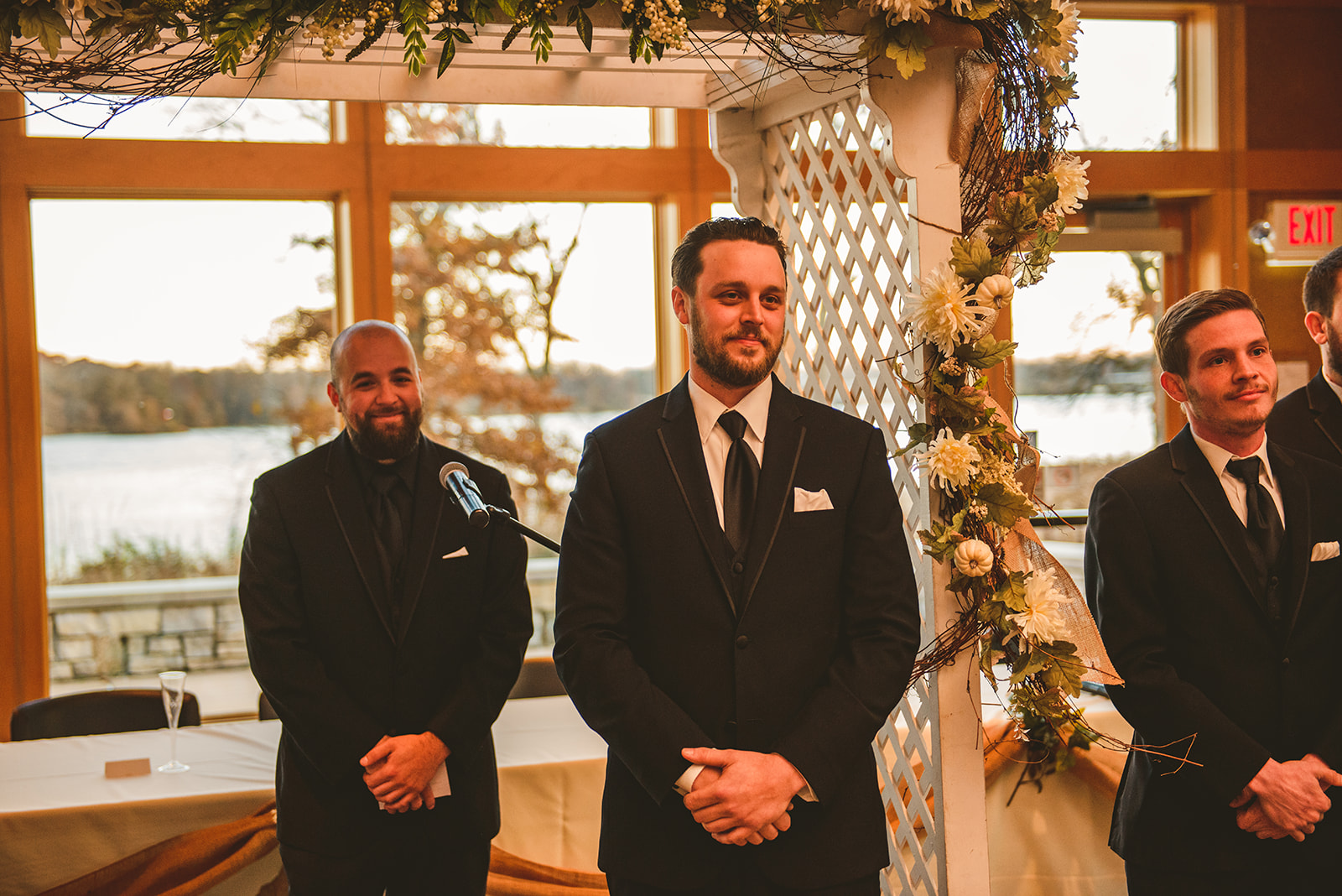 the groom seeing his bride for the first time as she walks down the aisle at the Four Rivers Environmental Education Center in Channahon