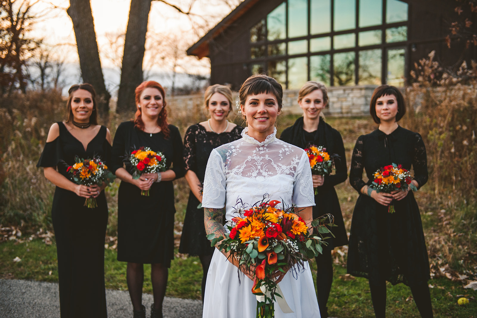 a bride standing in front of her bridesmaids as they all smile