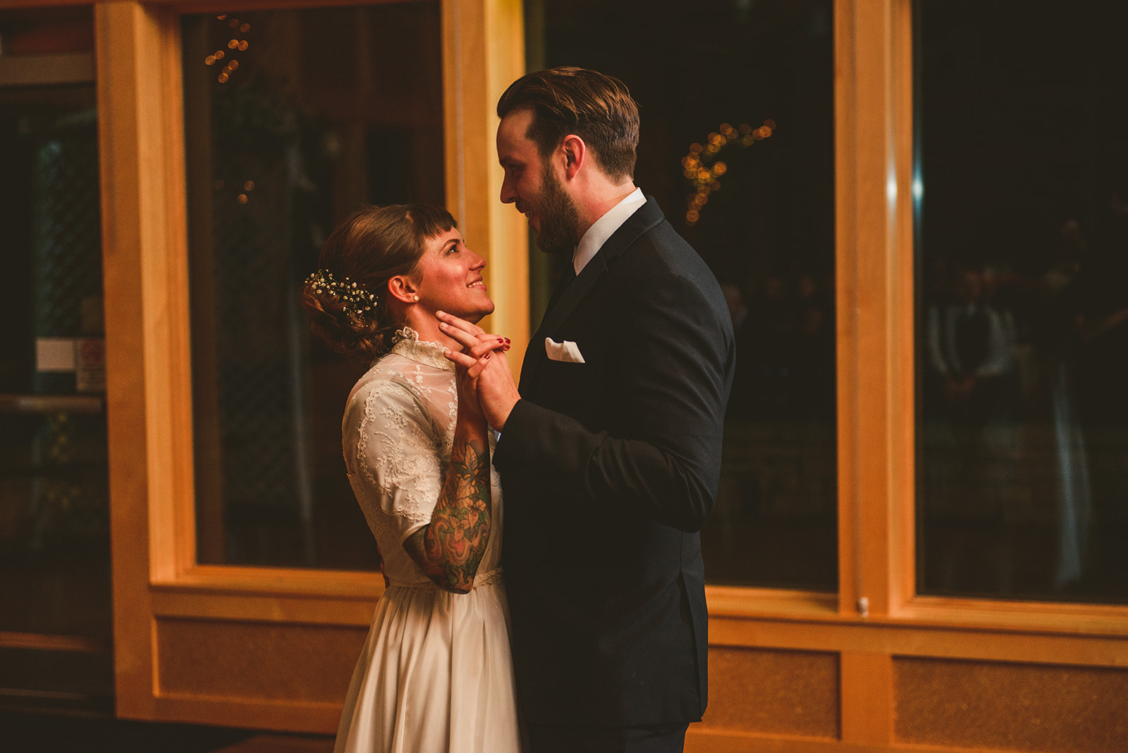 a bride and groom dancing for the first time as husband and wife as their friends watch