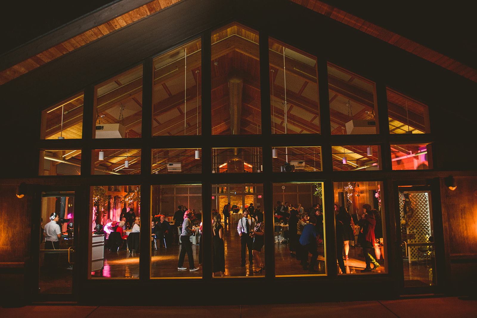 the exterior of the Four Rivers Environmental Education Center at night with a wedding reception taking place