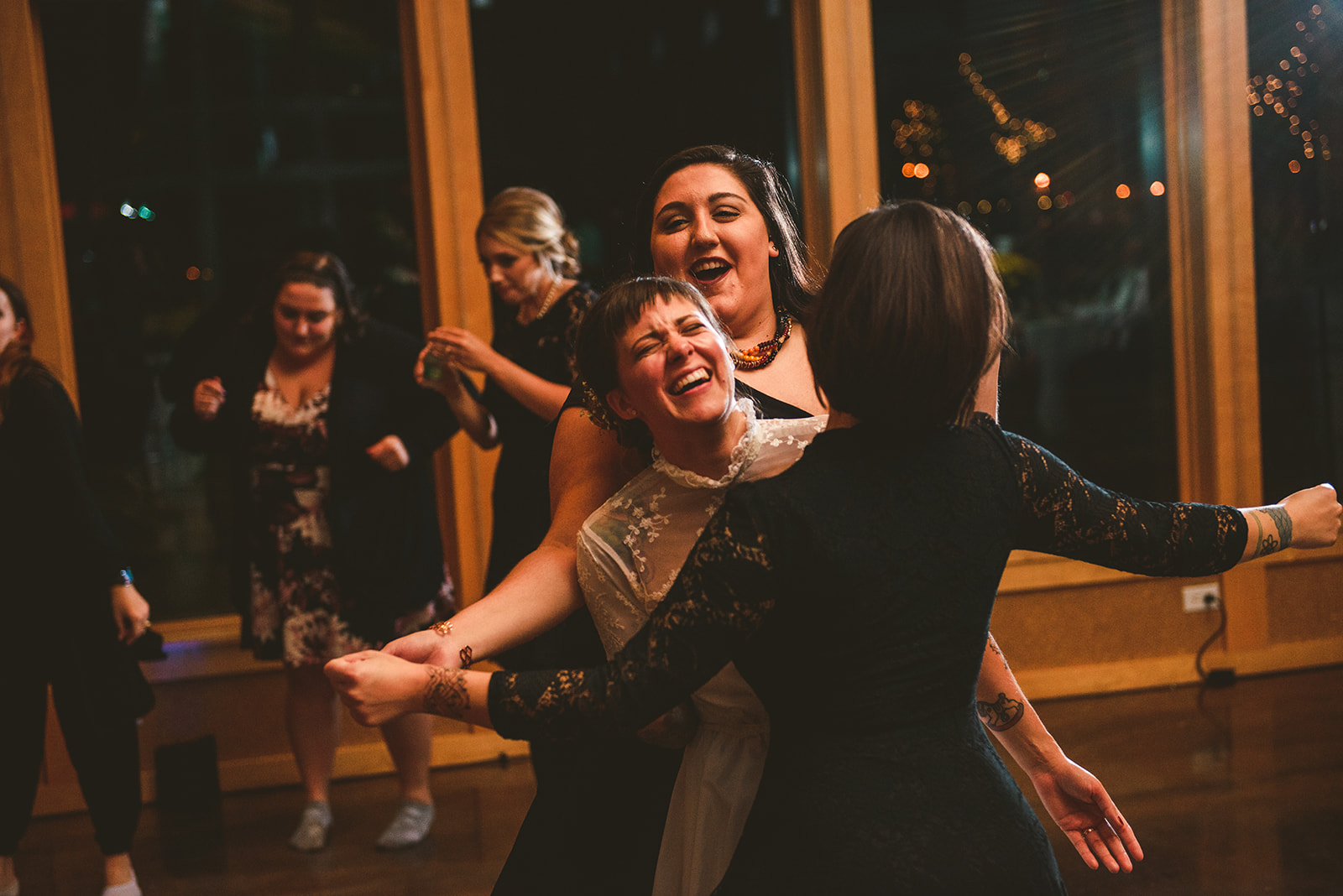 two girls dancing with the bride as they all laugh at the Four Rivers Environmental Education Center