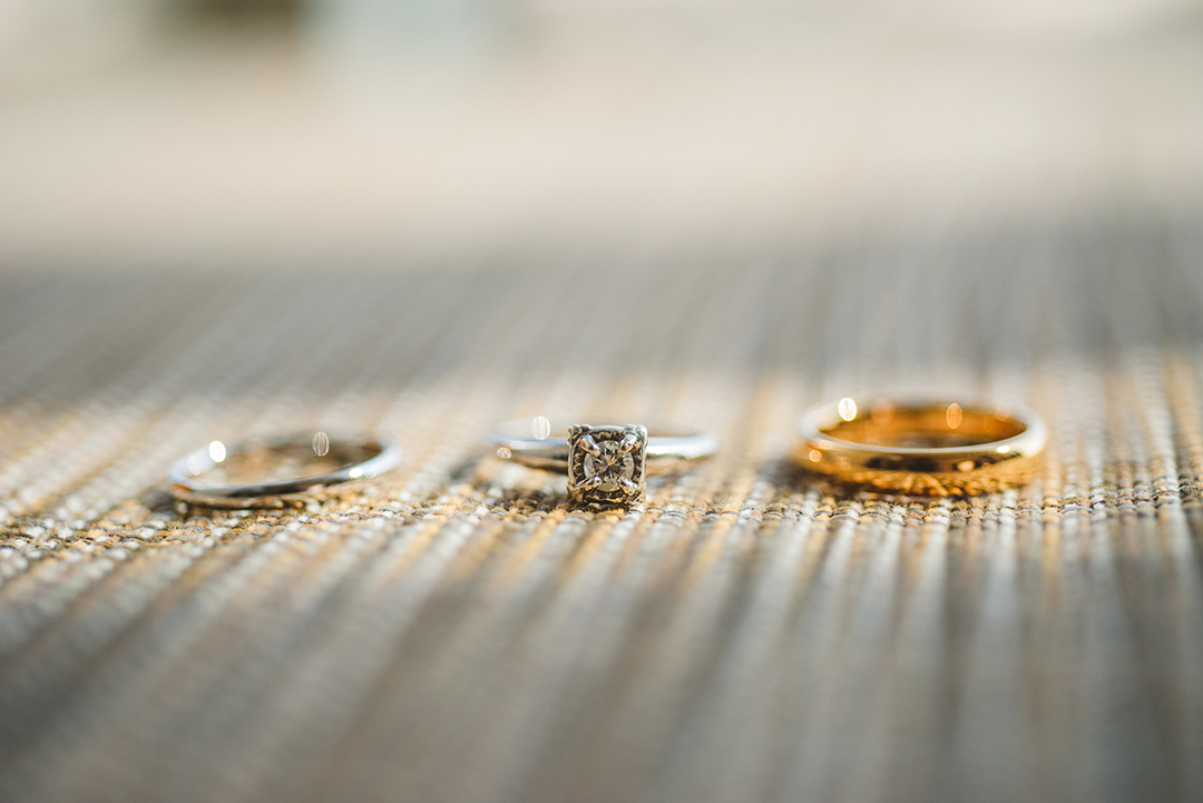 three wedding rings in a ray of sunlight in a room at the Hotel Arista in Naperville