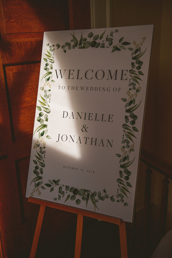 sunlight cascading over a welcome sign at a downtown Naperville wedding reception