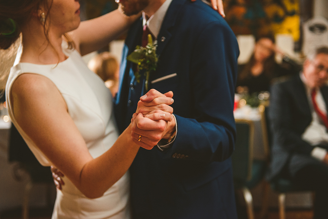 detail shot of a bride and grooms hands during their first dance in downtown Naperville