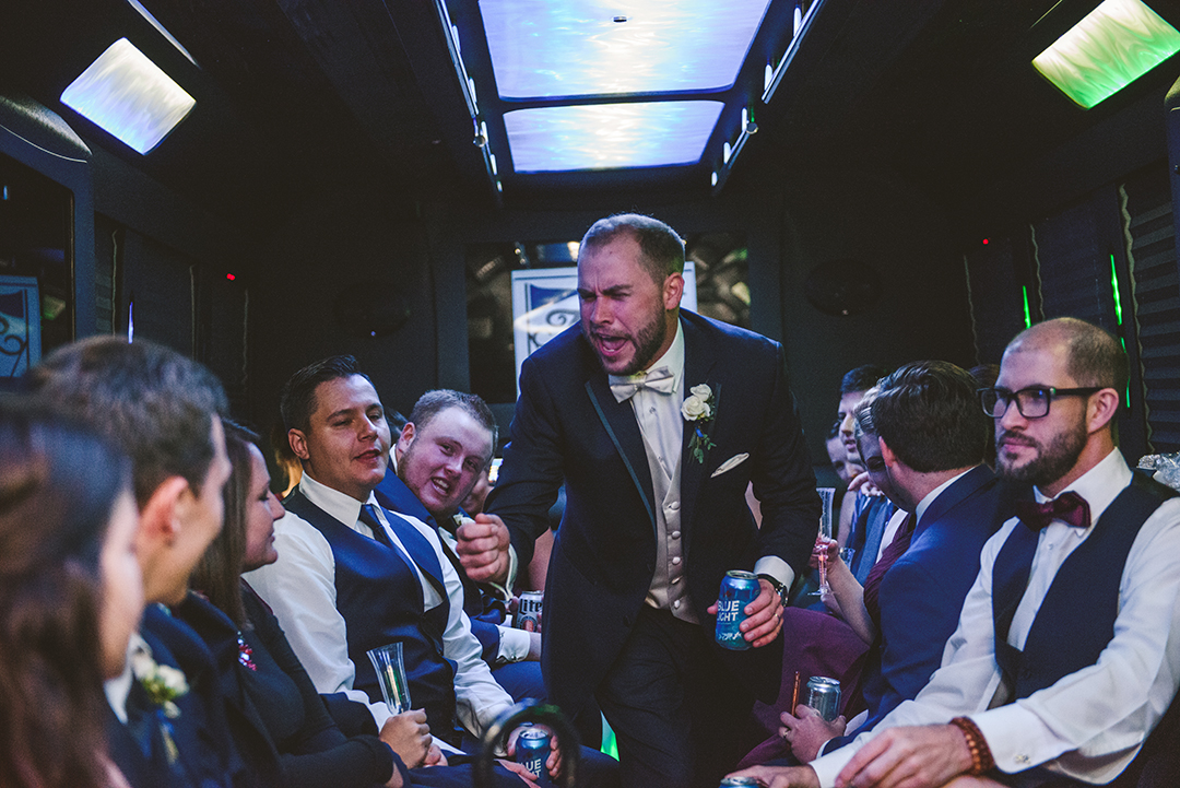 a groom singing on a party bus with his friends at a Cantigny Park wedding