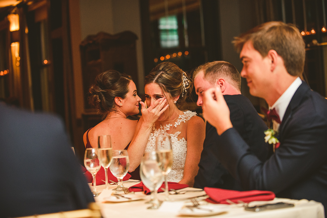 a bride crying as her father gives a speech at her wedding reception as everyone smiles at the Cress Creek Country Club in Naperville