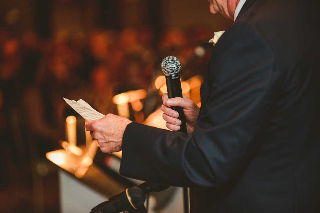 a close up of the father of the bride holding onto his speech at a wedding reception at the Cress Creek Country Club in Naperville